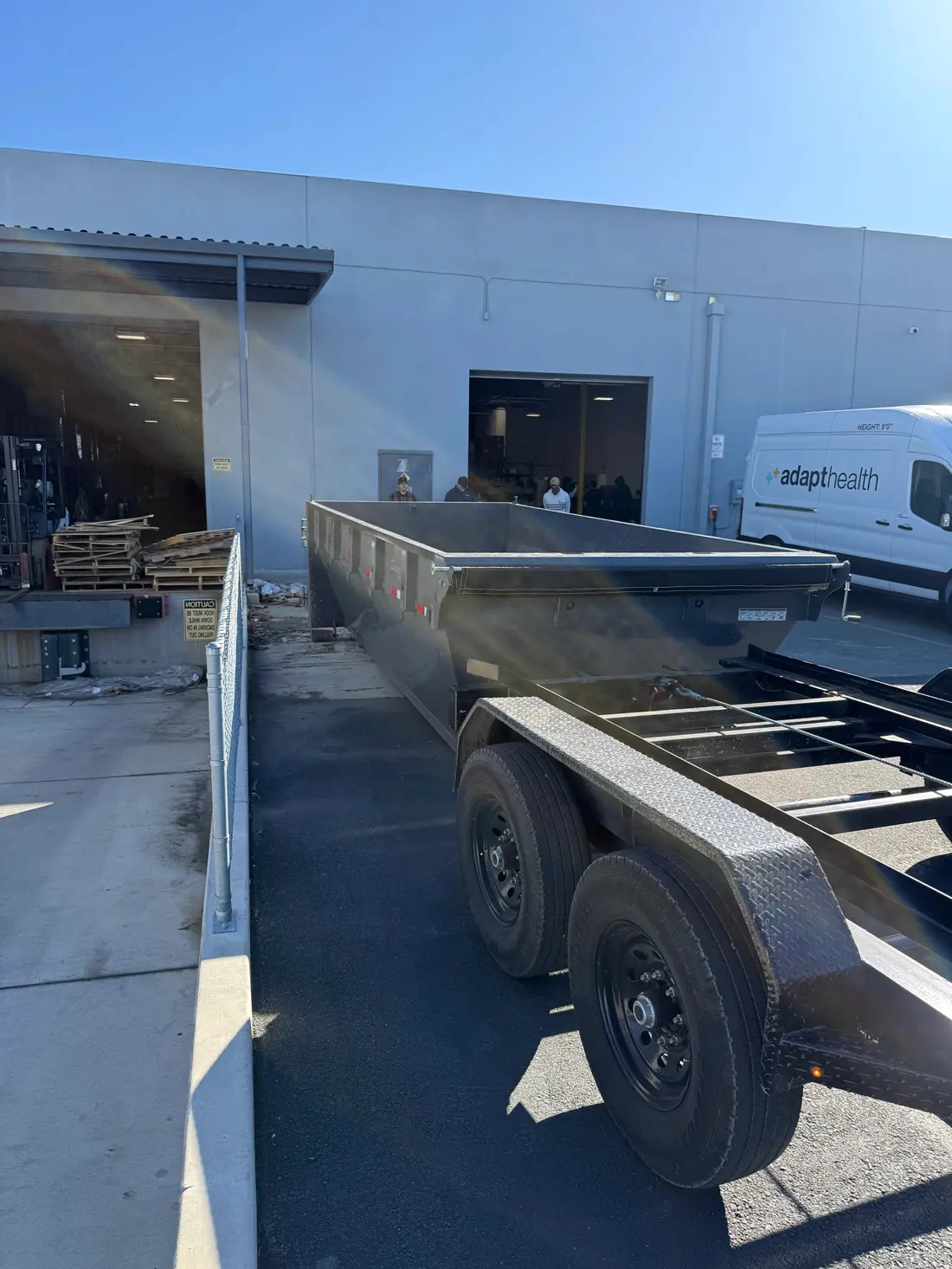 Dumpster staged at a commercial loading dock