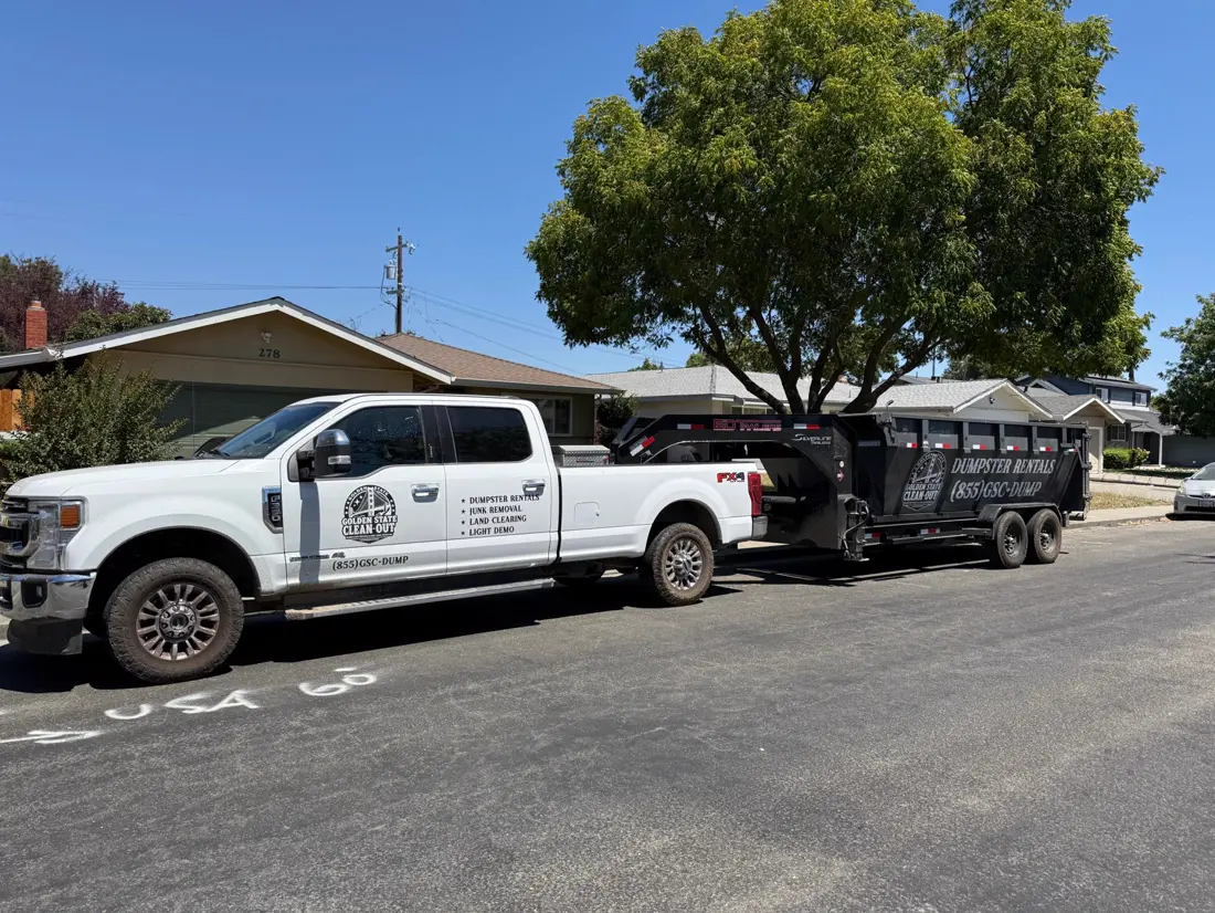 Roll-off hoist tipped up during a driveway delivery